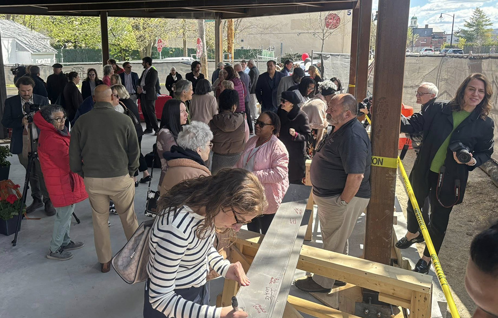 Stop Wasting Abandoned Property holds beam signing at 1077 Westminster - affordable apartment building